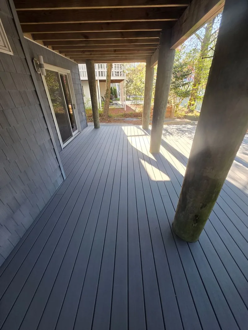 Composite deck installation with gray decking under home Sussex County Delaware