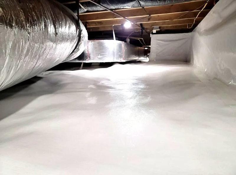 Crawl space vapor barrier sealed edge detail against stem wall